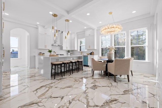 dining room featuring ornamental molding, a notable chandelier, and beam ceiling