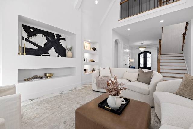 living room with built in shelves, french doors, high vaulted ceiling, and beamed ceiling