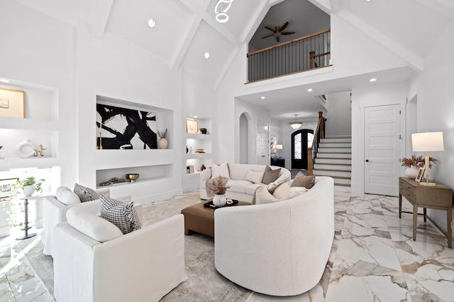 living room with built in shelves, high vaulted ceiling, ceiling fan, and beam ceiling