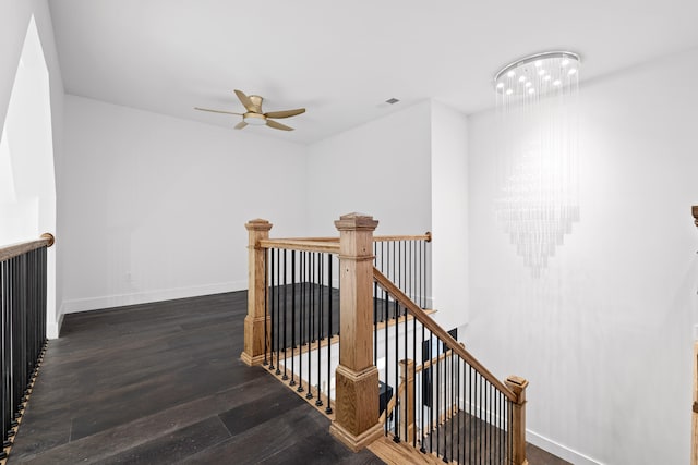 stairway featuring ceiling fan and hardwood / wood-style floors