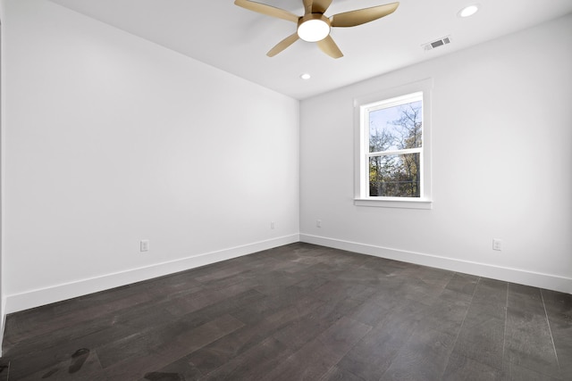 spare room featuring dark hardwood / wood-style floors and ceiling fan