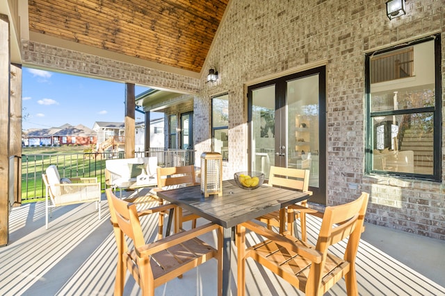 sunroom featuring lofted ceiling