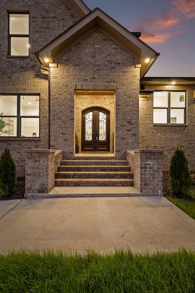 exterior entry at dusk with french doors