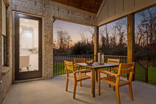 sunroom / solarium featuring lofted ceiling