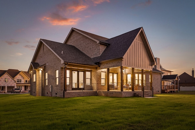 property exterior at dusk with a lawn