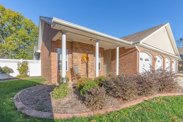 view of front of house featuring covered porch and a garage