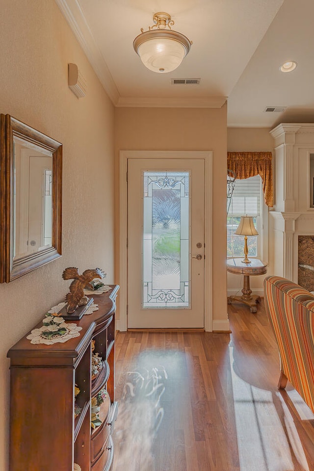 foyer entrance featuring light hardwood / wood-style flooring and ornamental molding