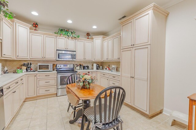 6315 Laramie Cir, Chattanooga, TN 37421 - kitchen with appliances with stainless steel finishes, tasteful backsplash, cream cabinets, recessed lighting, and light tile patterned floors