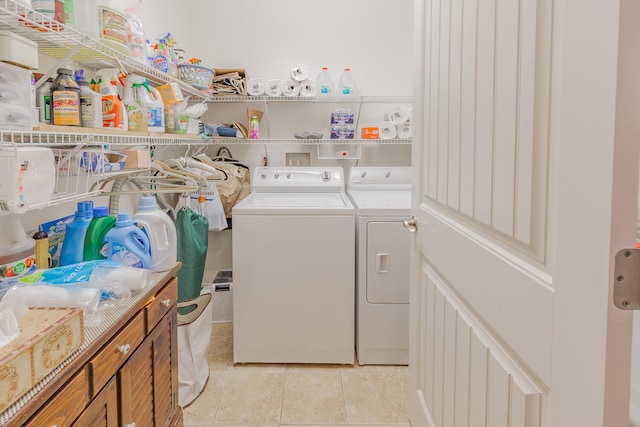 laundry area featuring separate washer and dryer and light tile patterned floors