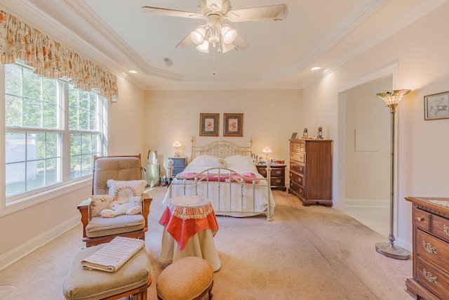 bedroom with light carpet, a tray ceiling, ceiling fan, and ornamental molding