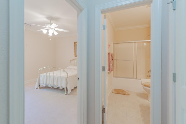 bathroom with bath / shower combo with glass door, crown molding, tile patterned flooring, ceiling fan, and toilet