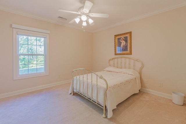 carpeted bedroom with ceiling fan and ornamental molding