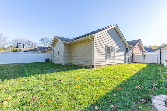 view of property exterior featuring central AC unit and a yard