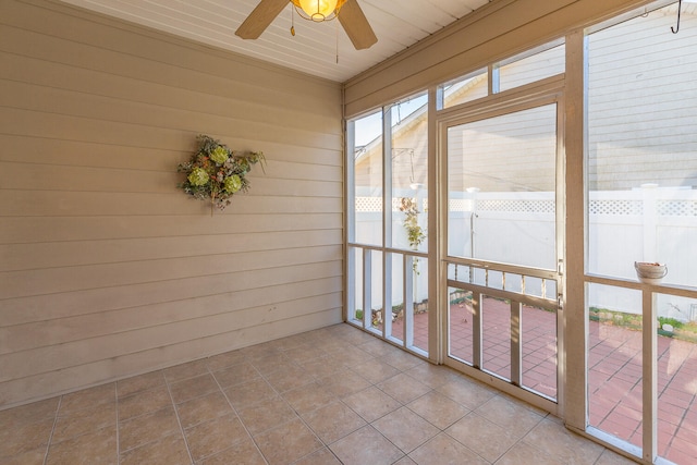 unfurnished sunroom featuring ceiling fan and wood ceiling