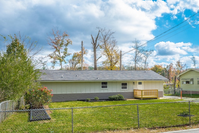 back of house with a lawn and a deck