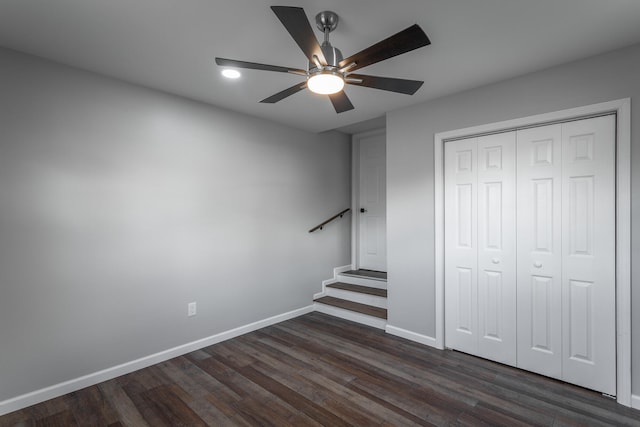 unfurnished bedroom featuring a closet, dark hardwood / wood-style floors, and ceiling fan