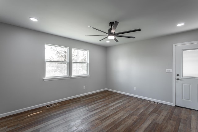 empty room with ceiling fan and dark hardwood / wood-style flooring