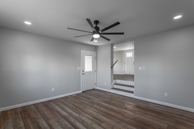 spare room featuring dark hardwood / wood-style flooring and ceiling fan