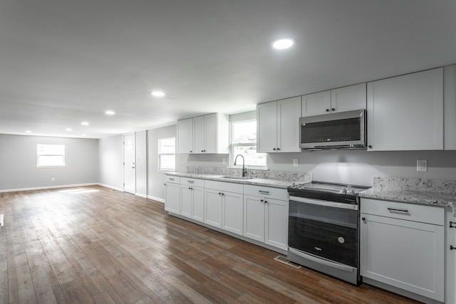 kitchen featuring white cabinetry, a healthy amount of sunlight, and appliances with stainless steel finishes