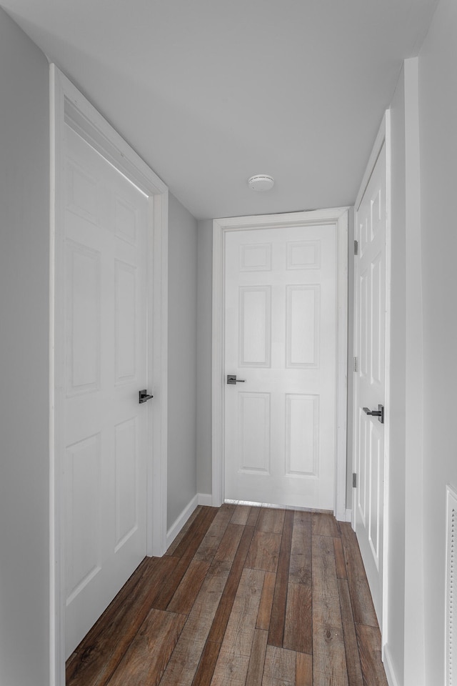 corridor featuring dark hardwood / wood-style flooring