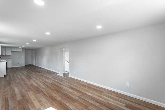 unfurnished living room featuring dark wood-type flooring