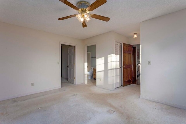 carpeted spare room with ceiling fan and a textured ceiling