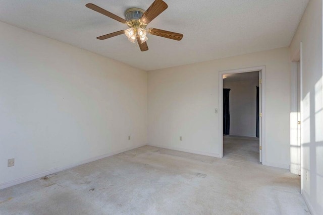 carpeted spare room with ceiling fan and a textured ceiling