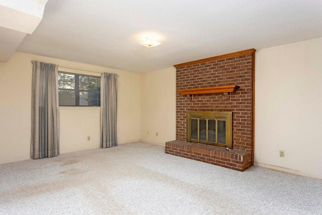 unfurnished living room featuring a textured ceiling, carpet floors, and a brick fireplace