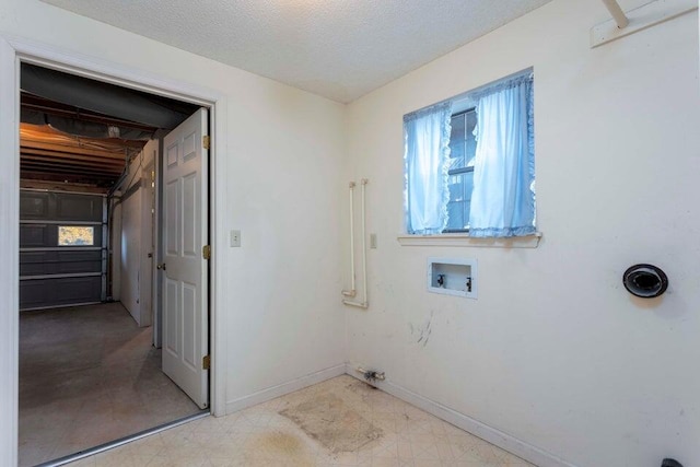 laundry area featuring hookup for a washing machine and a textured ceiling