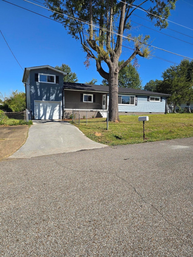 view of front of house featuring a garage and a front lawn