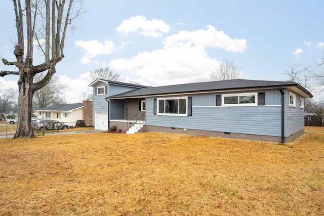 view of front of house featuring a garage and a front yard