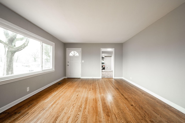 unfurnished living room featuring light wood-type flooring