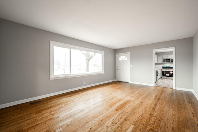 unfurnished living room featuring light wood-type flooring