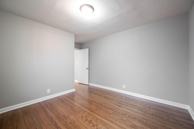 empty room with hardwood / wood-style floors