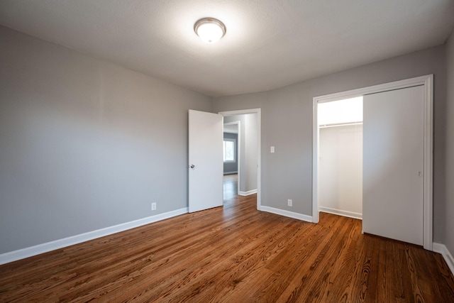 unfurnished bedroom featuring hardwood / wood-style flooring and a closet