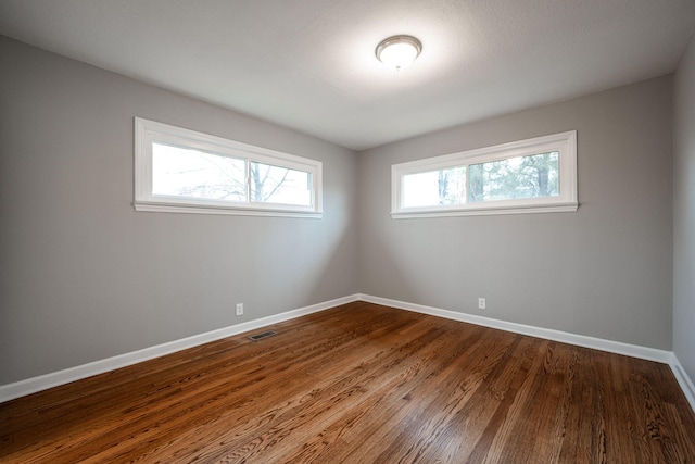 spare room with hardwood / wood-style floors