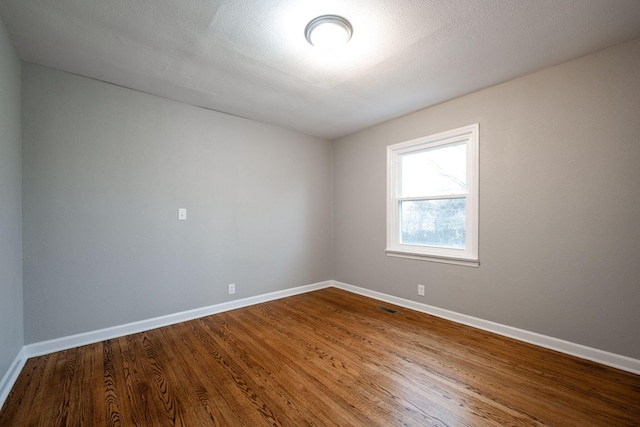 unfurnished room with hardwood / wood-style floors