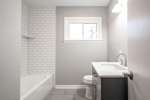 full bathroom with tile patterned flooring, vanity, tiled shower / bath, and toilet