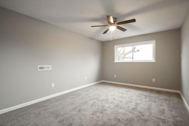 unfurnished room featuring a textured ceiling, ceiling fan, and carpet flooring