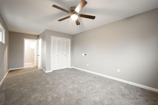 unfurnished bedroom featuring a closet, ceiling fan, and carpet