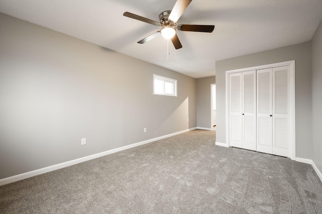 unfurnished bedroom featuring carpet flooring, ceiling fan, and a closet