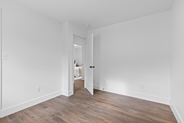 unfurnished bedroom with dark hardwood / wood-style flooring