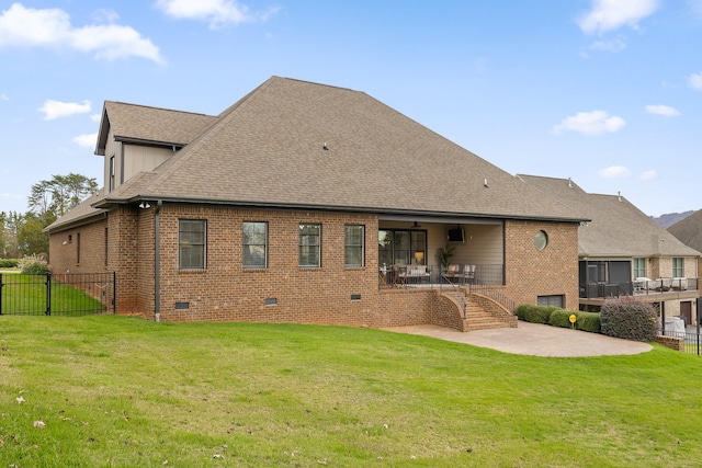 rear view of house featuring a yard and a patio area