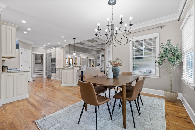 dining area with light wood-type flooring, crown molding, and a chandelier