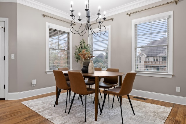 dining area featuring hardwood / wood-style floors, plenty of natural light, and a chandelier