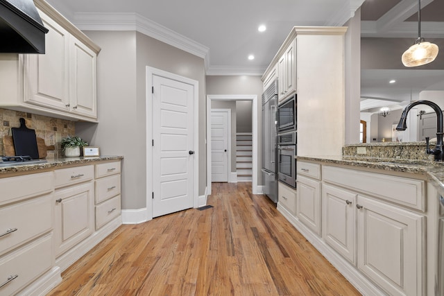 kitchen featuring custom exhaust hood, backsplash, sink, light hardwood / wood-style flooring, and stainless steel appliances