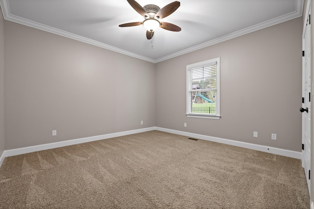 carpeted empty room featuring ceiling fan and crown molding