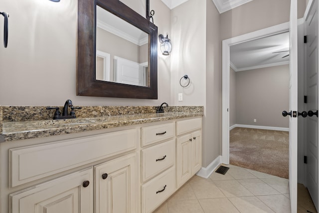 bathroom with tile patterned flooring, vanity, and ornamental molding