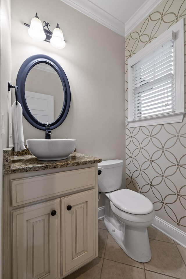 bathroom with tile patterned flooring, vanity, ornamental molding, and toilet