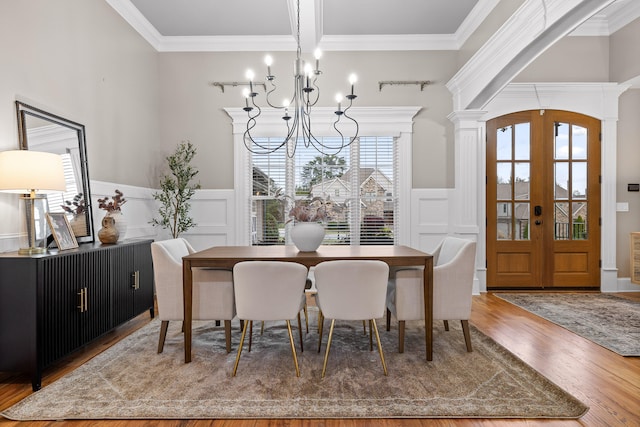 dining room featuring crown molding, a wealth of natural light, french doors, and hardwood / wood-style floors